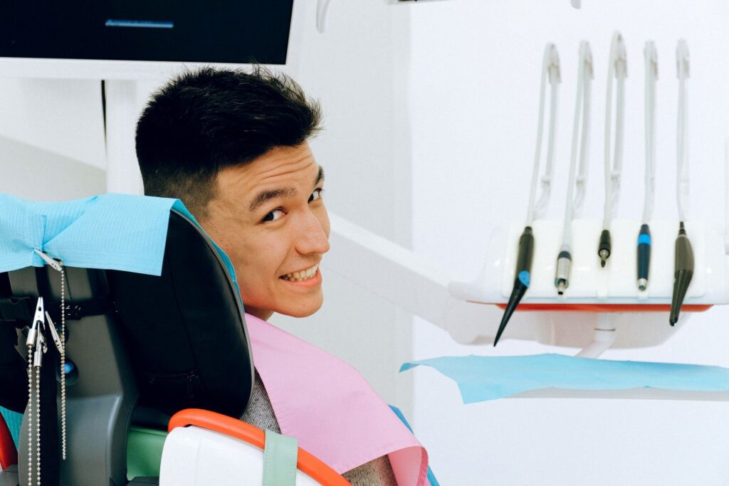 Smiling patient seated in a dental chair before treatment