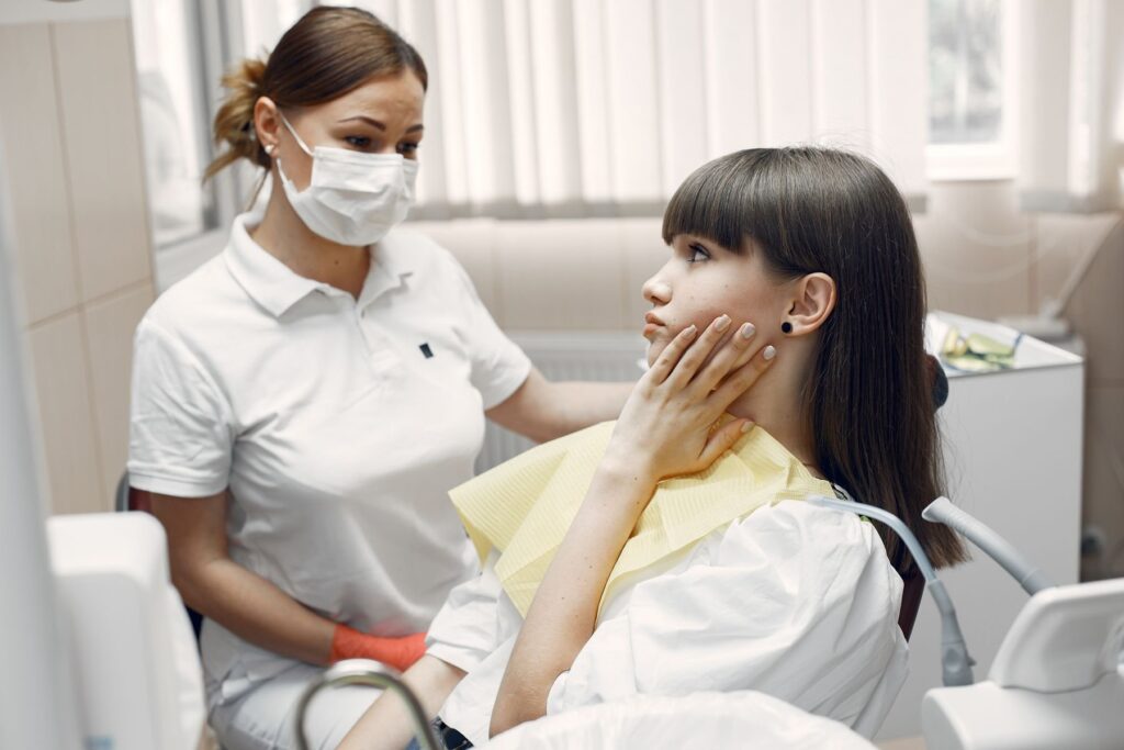Dental assistant and patient during an examination for a toothache
