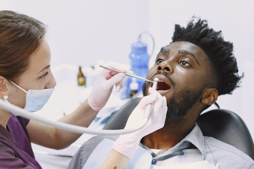 Dental hygienist examining a patient's teeth during a routine checkup