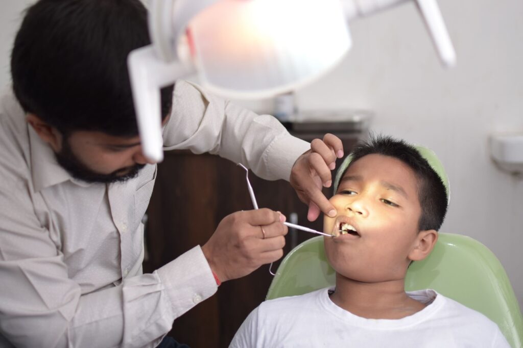 Dentist examining a child's teeth in a dental clinic